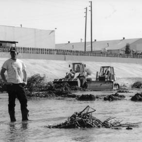 Lewis MacAdams, founder of Friends of the Los Angeles River, stands in the river as bulldozers clear vegetation from its channel in anticipation of heavy El Nino-driven rains, expected in the winter of 1997-98 | Blake Gumprecht, courtesy of FoLAR