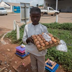 Moses, 10, sells eggs outside a petrol station to support his family. Child rights organisations say they are seeing a rise in child labour during the coronavirus pandemic. Photo taken on June 22, 2020, in Gulu, northern Uganda. Sally Hayden/Thomson Reute