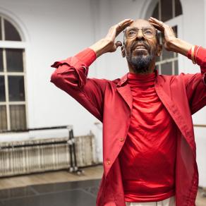 Wider on Dudley Williams in red with both arms raised. | "America ReFramed: Winter at Westbeth"